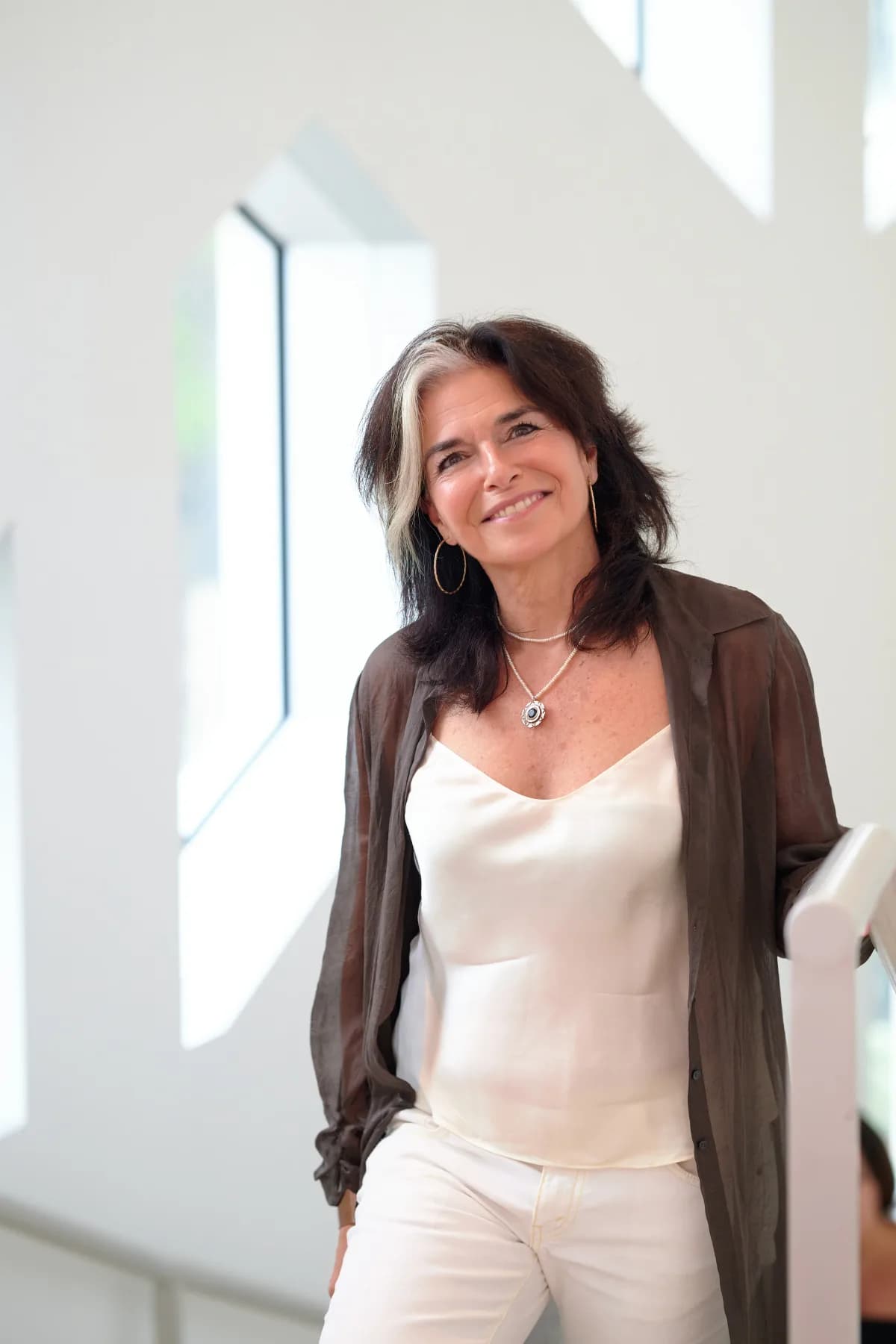 Nathalie Niddam standing confidently by a window